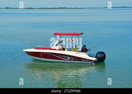 Grado, Italie - 11 août 2023, un couple dans un bateau de pêche dans la section Grado de la lagune de Marano et Grado dans Frioul-Vénétie Julienne, N. E. Italie Banque D'Images