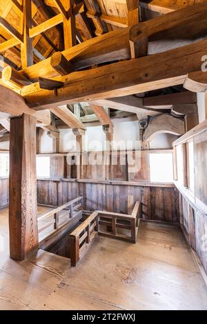 Intérieur du donjon en bois du château Bitchu Matsuyama. Le deuxième étage avec une grande colonne centrale, supportant des poutres en bois et chevrons de toit. Banque D'Images