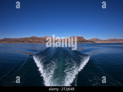 Sentier sur la surface de l'eau derrière le bateau à moteur sur le lac Titicaca, Pérou Banque D'Images