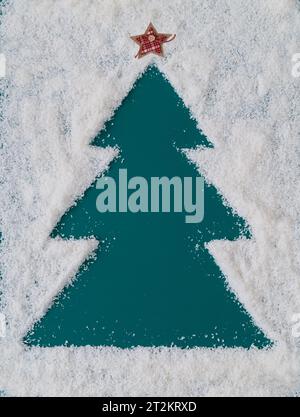 Arbre de Noël fabriqué dans la neige. Fond d'hiver créatif avec espace de copie. Concept minimal de Noël ou de nouvel an. Disposition des vacances d'hiver chic. Banque D'Images