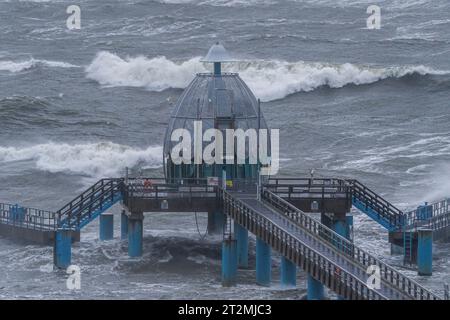 Sellin, Allemagne. 20 octobre 2023. Les vagues se balancent autour de la télécabine de plongée de la station balnéaire balte de Sellin. En raison d'une tempête basse, les premières rues et les zones côtières de la côte de la mer Baltique ont été inondées par les hautes eaux. Ainsi, le matin à Wismar ainsi qu'à Kiel et Flensburg de nombreuses rues et places étaient sous l'eau. Crédit : Georg Moritz/dpa/Alamy Live News Banque D'Images