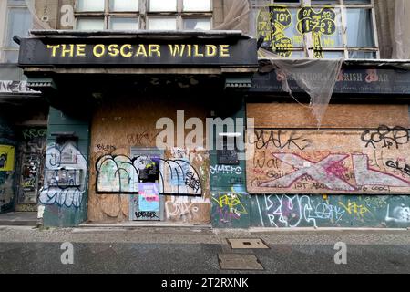 Stadtquartier am Tacheles DEU, Deutschland, Germany, Berlin, 07.10.2023 Geschlossener und mit Bretter vernagelte ehemaliger Pub The Oscar Wilde in der Friedrichstraße in Berlin Mitte Deutschland . Die gesamte Gegend befindet sich im Umbruch. Mit dem neuen Stadtquartier am Tacheles nahe dem ehemaligen Kunsthaus Tacheles in der Oranienburger Straße ist ein Berliner Luxuswohnquartier entstanden mit Luxusapartements Buerosn und Geschaeften, umgebaut von mehreren renommierten Architektenbueros, beauftragt vom Investor de Wilboont fermé sur le pub Friedrich Banque D'Images