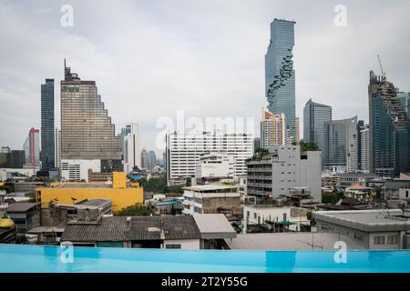 La vue de la Skyline de Bangkok regardant à travers la région de Silom et Sathorn de la ville montrant le gratte-ciel King Power Mahanakhon au loin. Banque D'Images