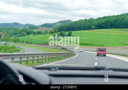 Conduite sur une autoroute à travers un paysage pittoresque dans - vue d'un pare-brise de voiture Banque D'Images