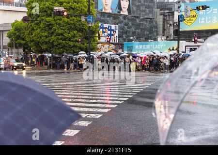 Tokyo, Japon - 08 avril 2023 : foule avec parapluies au point de passage de Shibuya avec des personnes non identifiées. C’est le passage piétonnier le plus fréquenté au monde, Banque D'Images