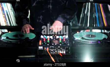 Berlin - Germany, december 6, 2022: Hands of soundman on the mixing console. Art. Working of sound designer. Stock Photo