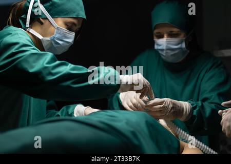 Équipe médicale effectuant la chirurgie en salle d'opération. Banque D'Images