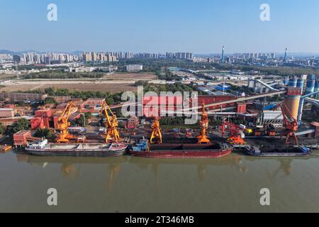 NANJING, CHINE - 23 OCTOBRE 2023 - les cargos accostent au terminal de matières premières de fer et d'acier de Meishan pour décharger le charbon à Nanjing, province du Jiangsu, Chin Banque D'Images
