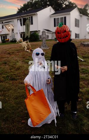 Enfants vêtus de costumes d'Halloween ; tours-ou-traiteurs Banque D'Images