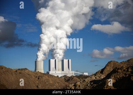 Leipzig, Allemagne. 23 octobre 2023. La centrale électrique au lignite de Lippendorf peut être vue derrière des monticules de terre d'une excavation. La centrale brûle le lignite des mines à ciel ouvert environnantes pour produire de l'électricité et de la chaleur. D'ici 2035 au plus tard, l'élimination progressive du lignite mettra également fin à la production d'électricité au charbon. Crédit : Jan Woitas/dpa/Alamy Live News Banque D'Images