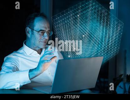 Image composite numérique de l'homme d'affaires utilisant un ordinateur portable avec cube 3D dans le bureau Banque D'Images