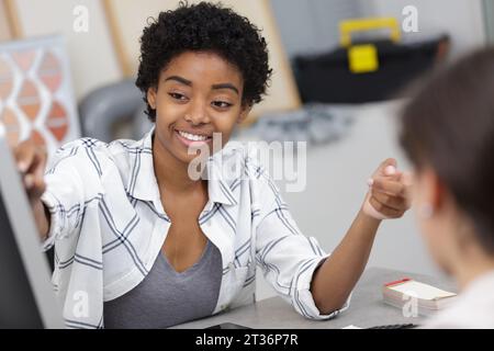 jeune femme d'affaires dans le bureau pointant vers pc Banque D'Images