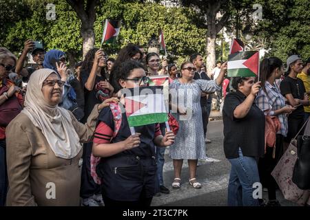 Les femmes debout dans la foule des militants pro-palestiniens avec le drapeau palestinien pendant le rassemblement au centre-ville de Tunis après l'explosion de l'hôpital à Gaza. Banque D'Images