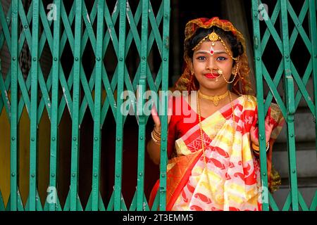 Kolkata, Inde. 23 octobre 2023. Une petite fille (Ananya) pose pour une photo avant le rituel Kumari Puja. Kumari Puja est une tradition indienne hindoue principalement célébrée pendant la Durga Puja suivant le calendrier hindou. La base philosophique de Kumari Puja est d'établir la valeur des femmes. Les dévots croient que cela surmontera tous les obstacles et les dangers pour les jeunes filles dans le futur à venir, et aussi, les jeunes filles seront habilitées à gérer tout stress et obstruction dans leur vie à venir. Crédit : SOPA Images Limited/Alamy Live News Banque D'Images