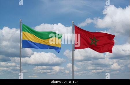 Drapeaux du Maroc et du Gabon agitant ensemble sur un ciel nuageux bleu, concept de relation entre deux pays Banque D'Images