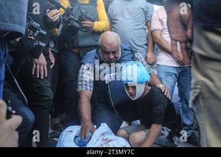 Camp de Nuseirat, Territoires palestiniens. 26 octobre 2023. Le correspondant d’Al-Jazeera, Wael Al-Dahdouh, pleure le corps des membres de sa famille, tués lors d’une frappe aérienne israélienne visant le camp de Nuseirat, avant d’être emmenés à l’hôpital Al-Aqsa de Deir Al-Balah pour leur dernière repose. Credit : Mohammed Talatene/dpa - ATTENTION : Graphic content/dpa/Alamy Live News Banque D'Images