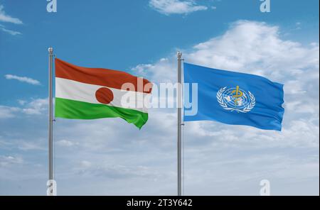 Drapeaux de l'Organisation mondiale de la Santé et du Niger agitant ensemble dans le vent sur un ciel nuageux bleu Banque D'Images