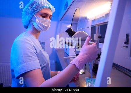 Un travailleur concentré du laboratoire Calm prépare du matériel biologique pour le stockage Banque D'Images