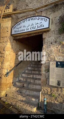 Une majestueuse entrée en pierre avec un mur et un panneau situé à l'avant : Old Jaffa Banque D'Images