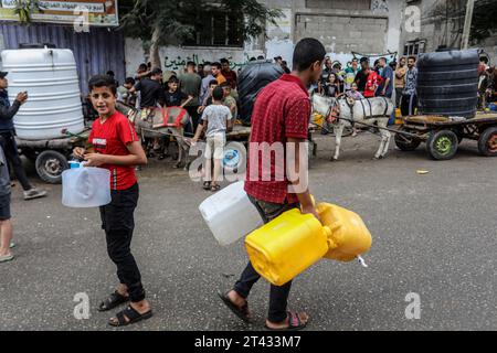 Rafah, Territoires palestiniens. 28 octobre 2023. Les Palestiniens attendent à un point de remplissage d’eau pour remplir leurs conteneurs d’eau, au milieu des combats en cours entre Israël et le groupe palestinien Hamas. Crédit : Abed Rahim Khatib/dpa/Alamy Live News Banque D'Images