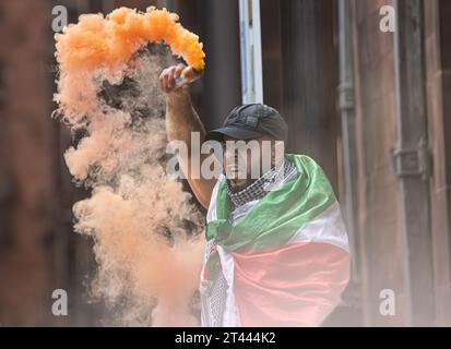 Man tient une torche alors que des milliers de manifestants pro-palestiniens se rassemblent pour une manifestation de masse à Manchester Royaume-Uni. Les manifestants ont défilé de la place Saint-Pierre dans le centre-ville. Drapeaux et banderoles ont été maintenus en altitude et des fusées éclairantes ont été larguées. Des discours ont été prononcés sur la place Saint-Pierre avant et après la marche circulaire. Photo : garyroberts/worldwidefeatures.com Banque D'Images