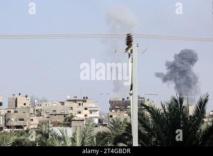 Gaza, Palestine. 30 octobre 2023. La fumée et la poussière montent après une frappe aérienne israélienne à Rafah, dans le sud de la bande de Gaza, au milieu des combats en cours entre Israël et le groupe palestinien Hamas. Des milliers de civils, Palestiniens et Israéliens, sont morts depuis le 7 octobre 2023, après que des militants palestiniens du Hamas basés dans la bande de Gaza sont entrés dans le sud d’Israël dans une attaque sans précédent déclenchant une guerre déclarée par Israël au Hamas avec des bombardements de représailles sur Gaza. Crédit : SOPA Images Limited/Alamy Live News Banque D'Images