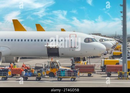 Plusieurs avions de suite dans le parking de l'aéroport subissant des travaux de maintenance avant et après le vol Banque D'Images