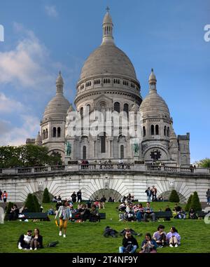 Sacré coeur de Montmartre, devant les touristes dans un pré, Paris, France Banque D'Images