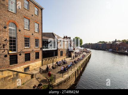 Regardant vers le bas les membres du public qui apprécient la nourriture et les boissons au bord de la rivière à York, en Angleterre Banque D'Images