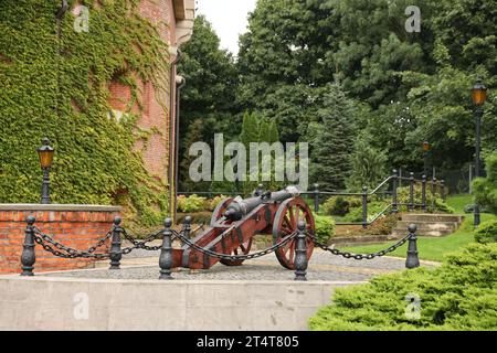 LVIV, UKRAINE - 11 SEPTEMBRE 2022 Un jardin paysager pittoresque à la citadelle de Lviv. Fortification bâtiment défensif en briques du Moyen âge. Canons médiévaux en fonte avec anneaux en bois Banque D'Images