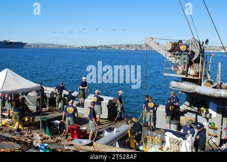 1102128720O-006 SAN DIEGO (12 février 2011) les marins affectés à l'unité mobile de plongée et de sauvetage (MDSU) 1 effectuent une plongée d'entraînement en tant qu'avions participant à la Parade of Flight, un spectacle aérien présentant des avions navals historiques et actuels pour célébrer le centenaire de l'aviation navale, survolent au-dessus. Le MDSU-1 s'entraîne à bord du navire de sauvetage et de sauvetage USNS Salvor (T-ARS 52) du Military Sealift Command alors qu'il est amarré à la base aéronavale North Island en préparation d'un déploiement dans la zone de responsabilité de la 7e flotte américaine. Marine Banque D'Images