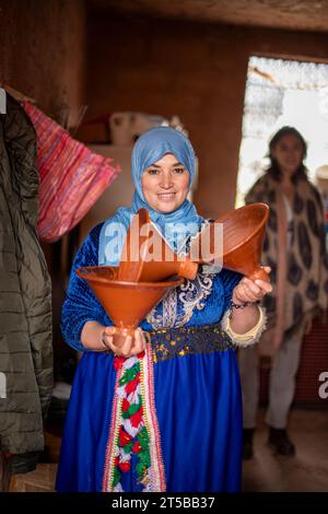 Une femme berbère avec des Tagins marocains dans les montagnes de l'Atlas Maroc Banque D'Images