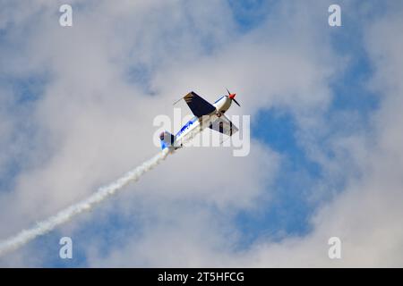 Skopje, Macédoine. L'avion acrobatique français Extra 330SC avec une traînée de fumée il a fait des miracles au-dessus de la tête des spectateurs. Banque D'Images