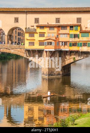 Florence, Italie. 2013. Homme en bateau à rames sur l ' Arno sous le pont Ponte Vecchio avec un reflet du pont. Usage éditorial uniquement. Banque D'Images