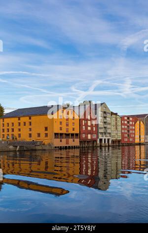 Les entrepôts riverains colorés quais les bâtiments de Bakklandet sur pilotis avec des reflets dans la rivière Nidelva à Trondheim, Norvège, Scandinavie, Europe Banque D'Images