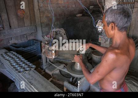 Kolkata, Inde. 06 novembre 2023. Un ouvrier fabrique une lampe en terre dans le village de poterie nommé Chaltaberia, à environ 40 km de la périphérie de Kolkata au Bengale occidental. Tout le village est en plein rythme de la production de lampes en terre et d'idoles avant le festival Diwali en Inde. Lampes en terre vendues dans toutes les villes indiennes comme Kolkata, Delhi, Mumbai, Hyderabad, Gujarat, Assam, Patna et Rajasthan, surtout pendant la saison des festivals. Même les lampes en terre sont exportées vers l'extérieur de l'Inde avant les célébrations de Diwali. (Photo Dipayan Bose/SOPA Images/Sipa USA) crédit : SIPA USA/Alamy Live News Banque D'Images