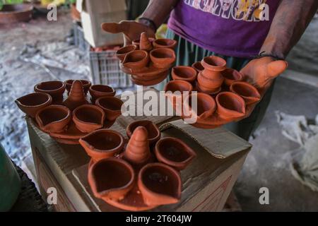 Kolkata, Bengale occidental, Inde. 6 novembre 2023. Un ouvrier trie une lampe en terre dans le village de poterie nommé Chaltaberia, à environ 40 km de la périphérie de Kolkata au Bengale occidental. Tout le village est en plein rythme de la production de lampes en terre et d'idoles avant le festival Diwali en Inde. Lampes en terre vendues dans toutes les villes indiennes comme Kolkata, Delhi, Mumbai, Hyderabad, Gujarat, Assam, Patna et Rajasthan, surtout pendant la saison des festivals. Même les lampes en terre sont exportées vers l'extérieur de l'Inde avant les célébrations de Diwali. (Image de crédit : © Dipayan Bose/SOPA Images via ZUMA Press Wire) EDITORIA Banque D'Images