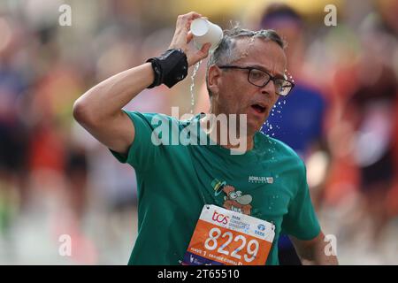 Un bénévole d’une station d’eau distribue des tasses d’eau sur la First Avenue lors du marathon de New York 2023, le dimanche 5 novembre 2023. (Gordon Donovan) Banque D'Images