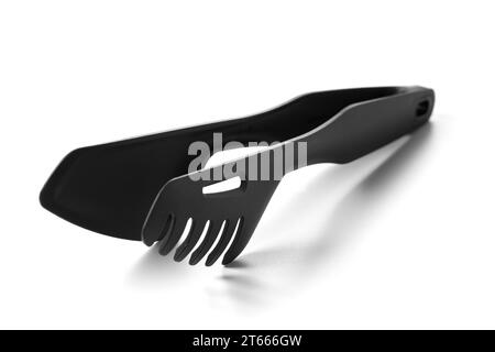 Pinces de cuisine noires démontables avec support éco-plastique. Ustensiles de cuisine pratiques pour préparer et servir des plats. Articles ménagers ergonomiques fabriqués Banque D'Images