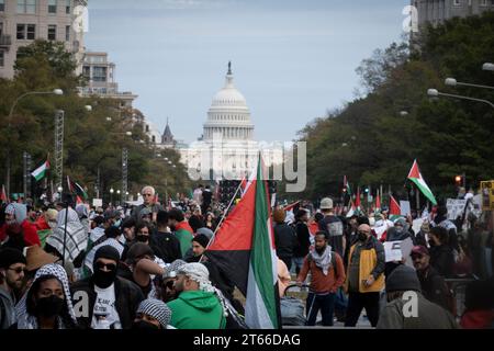 4 novembre 2023, Washington, District de Columbia, États-Unis : dans une manifestation frappante de solidarité, les participants à la marche de protestation pro-palestinienne se réunissent sur l'emblématique Pennsylvania Avenue, avec le Capitole des États-Unis en vue dégagée, servant de toile de fond puissante. Les manifestants, d’âge et d’origine divers, sont unis par leur appel commun à la fin des actions israéliennes à Gaza, à la suite d’un conflit déclenché par une attaque du Hamas qui a fait d’importantes victimes israéliennes. Les drapeaux palestiniens ondulent dans la foule, tandis que les manifestants portaient des keffiyehs traditionnels et des masques ma Banque D'Images