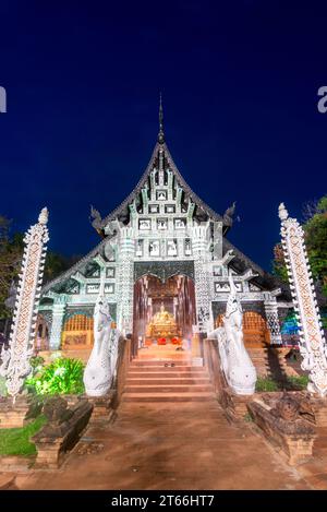 Illuminé par des lumières à l'intérieur et à l'extérieur de l'ancienne structure, les moines chantent et prient à l'intérieur, les chaussures laissées sur les marches de la porte, exquis, décora blanc complexe Banque D'Images