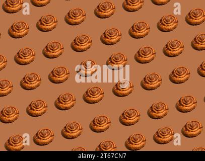 Motif Cinnabon sur fond brun. Photo de haute qualité Banque D'Images