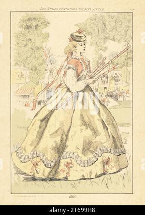 Dame à la mode à un fete ou une foire, Paris, 1866. Elle porte un chapeau, une veste boléro doublée de fourrure, des jupes fulls, et tient des bâtons rayés. En arrière-plan, la foule se tient devant les cabines, les tentes et les étals. Gravure à la main en pointe-seche ou en pointe par Henri Boutet des modes Feminines du XIXème siècle Siecle (Fashions féminines du 19th siècle), Ernest Flammarion, Paris, 1902. Boutet (1851-1919) est un artiste, graveur, lithographe et designer français. Banque D'Images