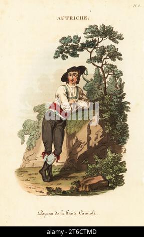 Homme de Slovénie (haute Carniole), 18e siècle. En chapeau à large bord, chemise blanche, bretelles vertes, culottes en cuir et buskins. Villageois de la haute Carniole. Gravure sur cuivre coloriée à la main d'après une illustration de William Alexander de J-B. Eyries l'Autriche : costumes, Moeurs et usages des autrichiens, Austria : costumes, Manners and Mores of the Austrians, Librairie de Gide fils, Paris, 1823. Jean-Baptiste Eyries (1767-1846) était un géographe, auteur et traducteur français. Banque D'Images