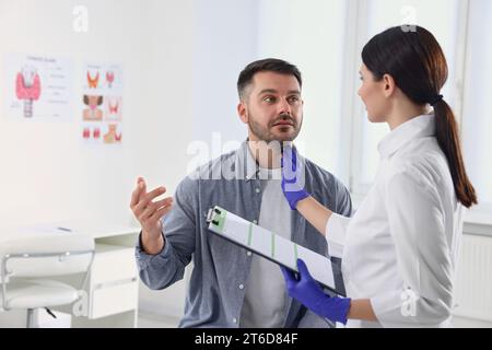 Endocrinologue examinant la glande thyroïde d'un patient à l'hôpital Banque D'Images