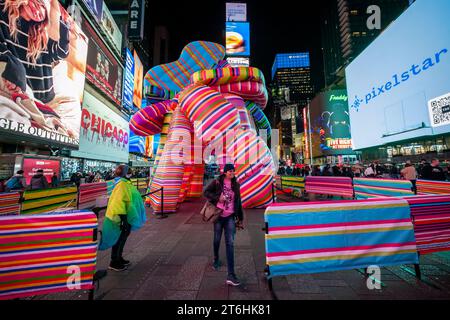 Les touristes affluent « Sculpture of Dreams », de l’artiste conceptuelle Marta Minujin à Times Square à New York le mercredi 8 novembre 2023. Présentée par Times Square Arts avec le Musée juif, la pièce gonflable de 16 est, selon les mots de Minujin, une « anti-sculpture » et est en conjonction avec une exposition de son travail au Musée juif. La maquette de la bulle sera exposée jusqu'au 21 novembre. (© Richard B. Levine) Banque D'Images