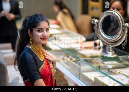 New Delhi, Inde. 10 novembre 2023. Une vendeuse présentant des bijoux à l'occasion de Dhanteras chez P.P. Jewellers by Pawan Gupta showroom dans South extension Market. Sur Dhanteras, il est une tradition commune pour les gens, en particulier en Inde, d'acheter de l'or, de l'argent ou d'autres métaux précieux et ustensiles. Cette pratique est considérée comme auspicieuse et est censée apporter prospérité et chance. (Photo Pradeep Gaur/SOPA Images/Sipa USA) crédit : SIPA USA/Alamy Live News Banque D'Images