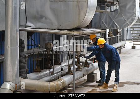 YANTAI, CHINE - 11 NOVEMBRE 2023 - Un membre du personnel d'une entreprise de chauffage vérifie le fonctionnement d'une chaudière à Yantai, dans la province de Shandong, en Chine, le 11 novembre 2023. (Photo de Costfoto/NurPhoto) Banque D'Images