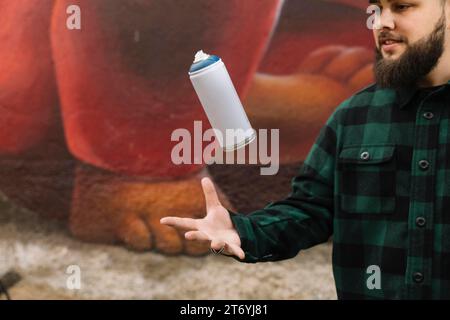 Barbe jeune homme jetant de l'air vaporisateur Banque D'Images