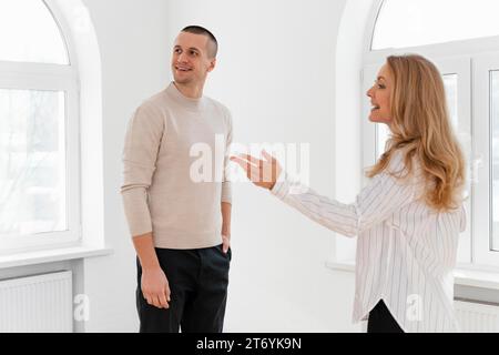 Femme agent immobilier montrant l'homme nouvelle maison Banque D'Images